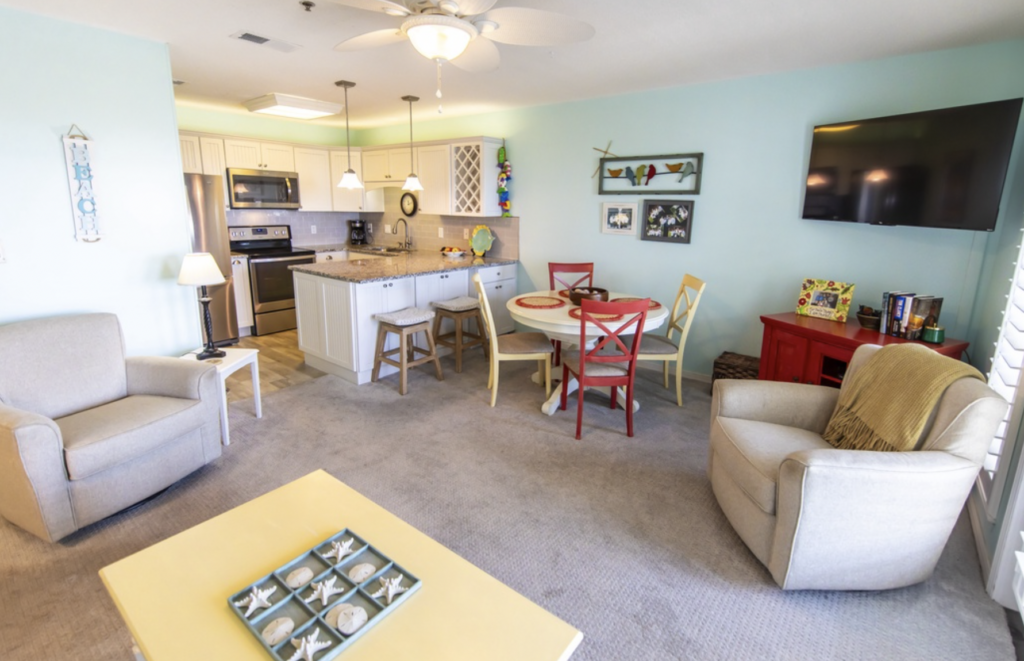 Living room, kitchen, and dining area in Gulf Place Caribbean 411 on 30A.