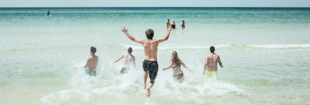 Family having fun at the beach near our 5 star vacation rentals on 30A